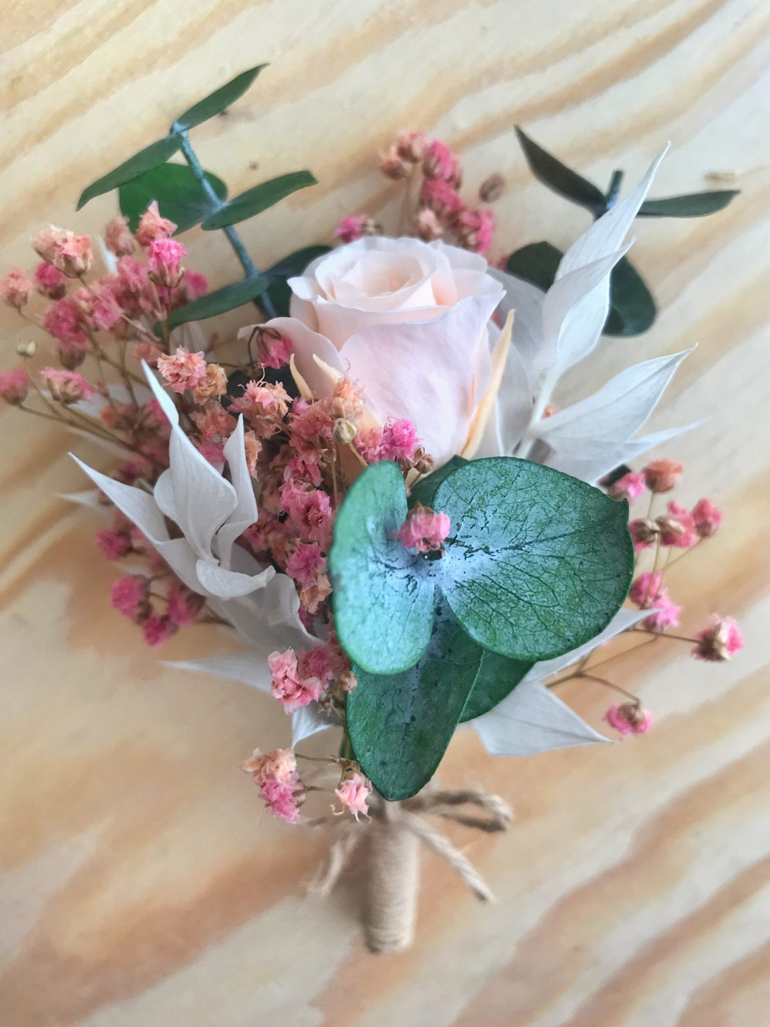 Dried flower wedding boutonniere with eternal rose, pink gypsophila and stabilized eucalyptus